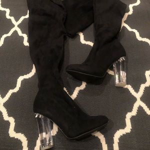 Over the knee boots with clear heel.